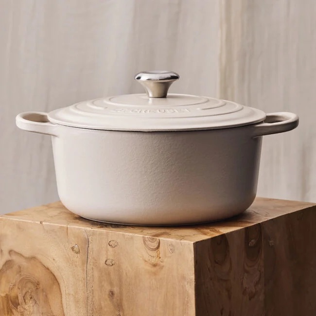 Cream enamel dutch oven on wood countertop